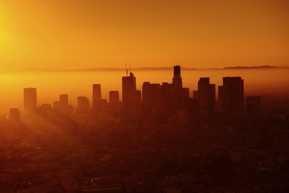 Warm orange sunset behind the skyline of Los Angeles. Original public domain image from Wikimedia Commons